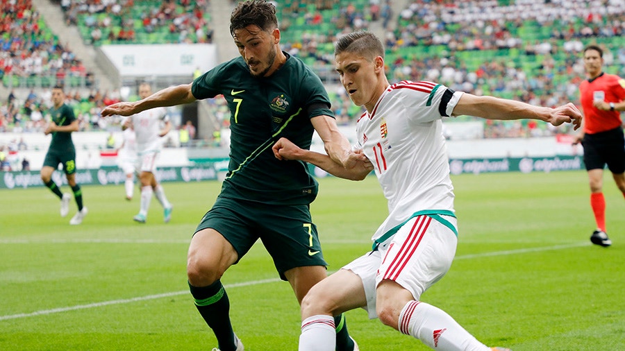 Mathew Leckie of Australia competes for the ball with Roland Sallai of Hungary.