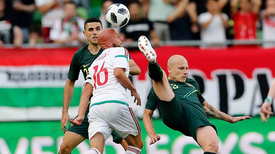 Aaron Mooy of Australia competes for the ball with Jozsef Varga of Hungary.