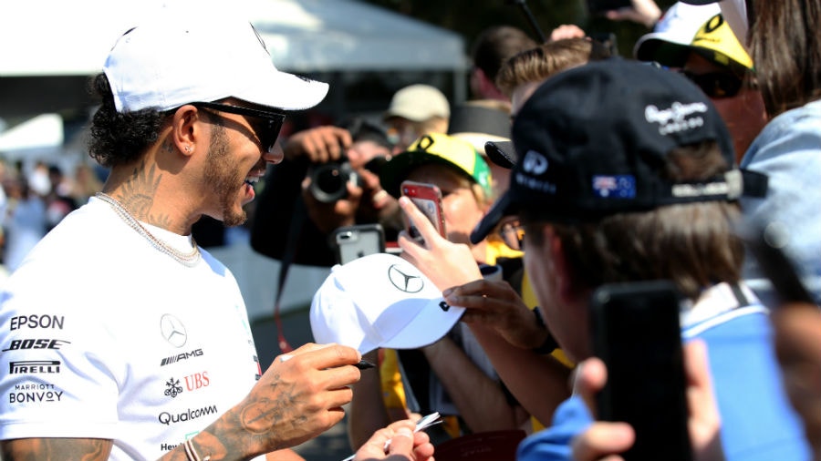 Lewis Hamilton of Great Britain and Mercedes GP arrives at the circuit and greets fans before the F1 Grand Prix of Australia