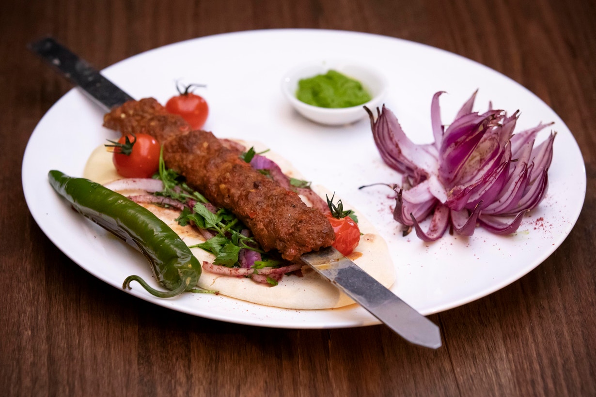 Adana Kebab with Flatbread, Red Lotus Onion and Green Parsley Vinaigrette
