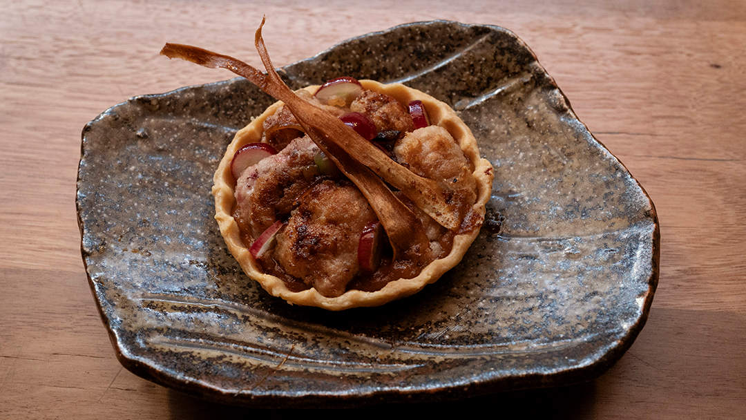 Sweetbread Tart with Caramelised Onion, Pickled Grapes & Parsnip Crisps